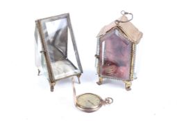 Two pocket watch stands and a gilt metal hunter-cased keyless pocket watch.