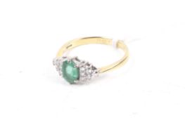 An 18ct gold, emerald and diamond dress ring.