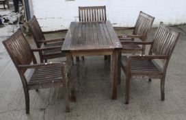 A set of wooden garden furniture. Including a rectangular garden table and five matching chairs.