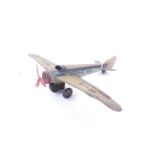 A vintage tin plate clockwork toy aeroplane.