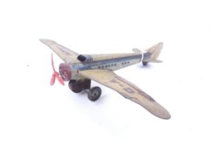 A vintage tin plate clockwork toy aeroplane.
