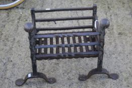 A vintage wraught iron riveted fire basket.