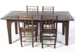 A rustic solid oak kitchen table and a set of four Georgian elm chairs.
