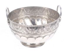 A large plated and embossed punch bowl.