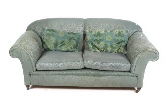 A 20th century Howard style scroll arm sofa.