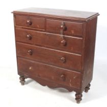 A 20th century stained pine chest of drawers.