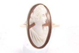 An early 20th century gold and oval shell cameo ring.