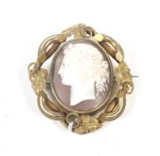 A Victorian gold plated and shell cameo oval locket-back brooch.
