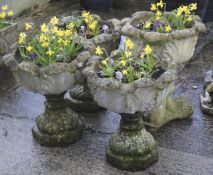 Four reconstituted stone garden urns.