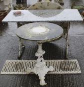 An antique garden bench and two tables. All with cast metal scrolling frames.