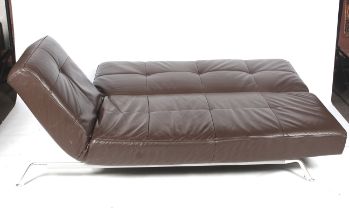 A Ligne Roset Smala brown leather sofa bed. Raised on metal support.