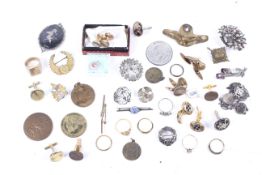 A miscellaneous collection of badges, medallions, costume jewellery and cufflinks.