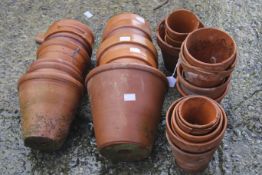 A collection of assorted small terracotta plant pots. Max.