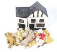 A collection of assorted soft toys and a dolls house.