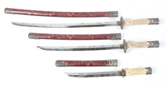 A contemporary unusual set of three matching Japanese swords.