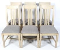 A set of six contemporary wooden dining chairs.