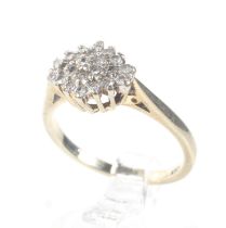 A modern 9ct gold and diamond cluster ring. The 23 round brilliant cut stones circa 0.