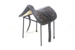 A vintage leather saddle stool.
