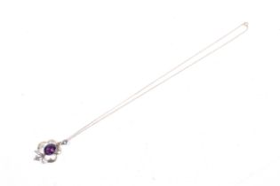 An Art Nouveau gold-plated, amethyst-coloured paste and imitation-pearl open-work pendant.