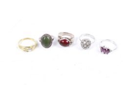 Five gem-set silver and white metal rings.