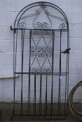 A pair of arch top wrought metal gates.