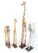 Four carved wooden models of African animals. Comprising two giraffes, an elephant and a camel, Max.