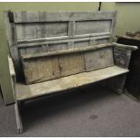 A rustic 19th century panel back settle bench.