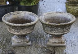 A pair of Sandford Stone garden urns.