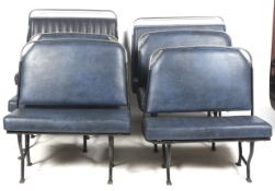 A set of six vintage two-seater bus seats.