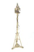 A converted brass floor standing oil lamp. With a tripod base.