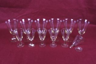 Two sets of six Swedish glass drinking glasses. With orange tinted bases and stems, Max. H13.