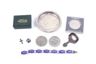 A silver caddy spoon and other items.