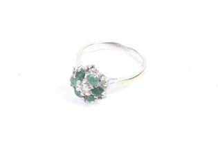 A vintage emerald and diamond cluster ring.