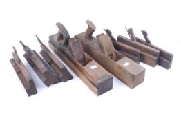 A collection of antique carpenter's wooden planes.