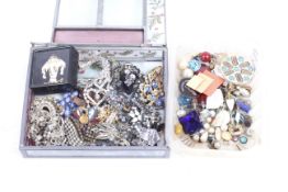 An assortment of costume jewellery in a stained glass jewellery box.