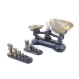 A set of Libra kitchen balance scales with two sets of weights.