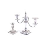 A late Victorian weighted silver candlestick and a silver-plated two-branch three-light candelabrum.