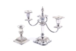 A late Victorian weighted silver candlestick and a silver-plated two-branch three-light candelabrum.