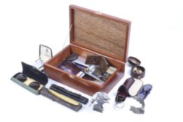 A mahogany box containing collectables.