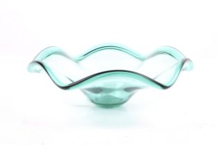 A retro green glass bowl with scalloped edge rim.