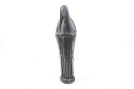 A carved ebonised wooden figure of the Virgin Mary in prayer.