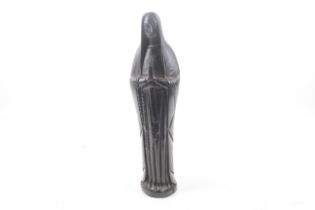 A carved ebonised wooden figure of the Virgin Mary in prayer.