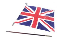 A vintage Girl Guides Union Jack flag and pole. Comes with brown leather shoulder harness.