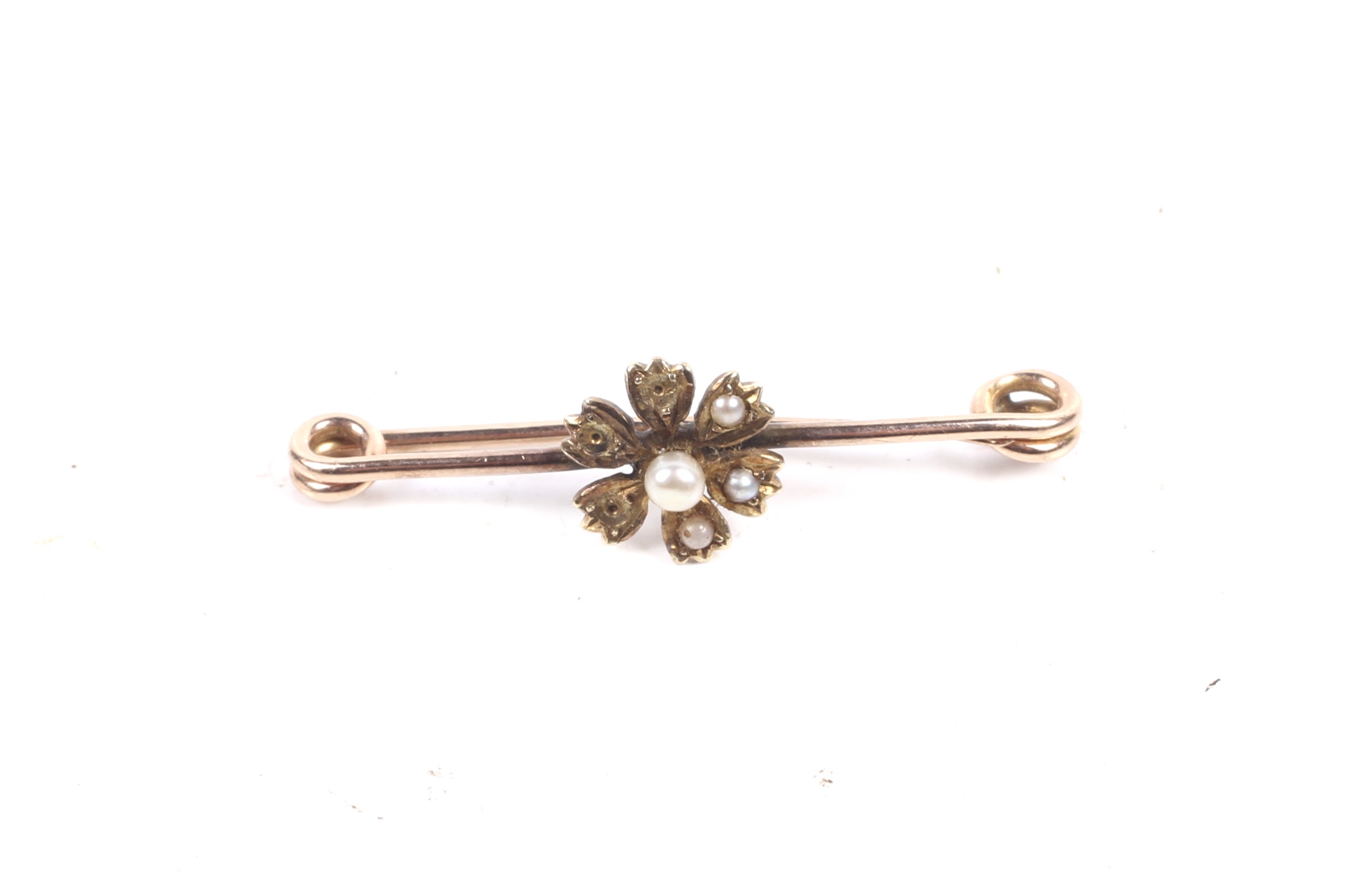 A late Victorian gold and half-pearl pin brooch.
