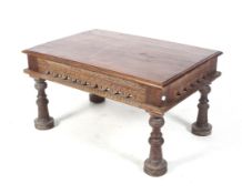 A far eastern carved hardwood coffee table. With carved frieze and turned splayed supports.
