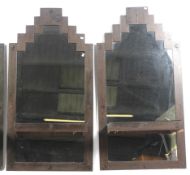 A pair of contemporary retro style metal framed wall mirrors.