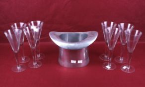 A vintage aluminium ice bucket top hat and a set of eight champagne flutes.