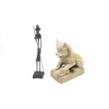 A ceramic Dog of Fo and a cast metal tribal figure.