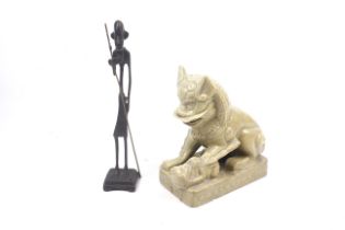 A ceramic Dog of Fo and a cast metal tribal figure.