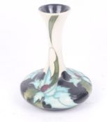 A Moorcroft Sea Holly vase. Designed by Emma Bossons, dated 2006. H16cm. (AF).